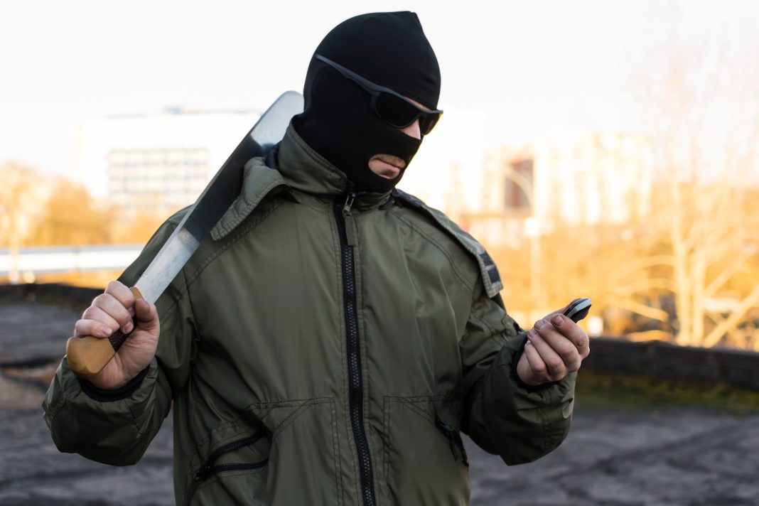 bandit criminal and masked man looking into the phone bandit criminal man mask coward gun anger army t kRm scaled