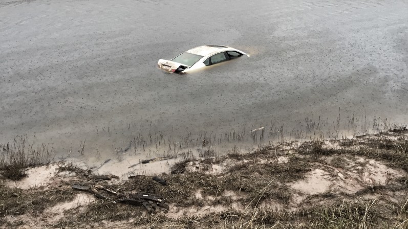 car submerged in water appears as flood water levels recede in fort bend county tx after houston a a t OxLaO